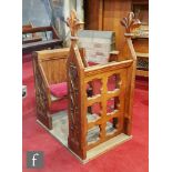 An oak alter chamber/reading stall with carved fleur de lys capitals over detailed armorial side