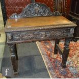 A Victorian carved oak side table fitted with a single lion mask drawer on conforming legs and