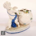 A 19th Century French cache pot modelled as a cherub pulling a ball with pierced decoration to the