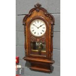 A late 19th Century walnut circular regulator wall clock with eight day striking movement enclosed
