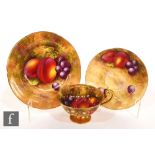 A Royal Worcester Fallen Fruits trio decorated by Ayrton and Townsend, the cup interior and saucer