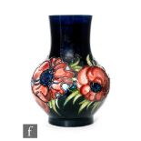 A Moorcroft vase of footed baluster form decorated in the Anemone pattern, impressed marks and