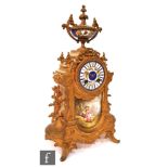 A late 19th to early 20th Century French gilt metal 8-day mantle clock, of architectural form, the