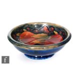 A small Moorcroft footed bowl decorated in the Pomegranate pattern with two whole and one open fruit