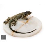 Bergman - An early 20th Century painted cold cast bronze lizard mounted on an onyx base, unmarked,