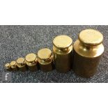 A set of seven brass Avery grocers weights, 1oz to 100oz. (7)