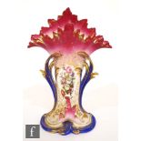 A 19th Century continental porcelain vase of compressed trumpet form with flared rim, hand painted