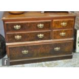 A Victorian walnut chest of four short and one long drawer, with faux burr walnut front panels,