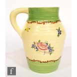 A Clarice Cliff Lotus shape jug decorated in the Pompadour pattern decorated with floral sprays on