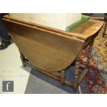 A 17th Century style oak gateleg dining table on turned block legs and stretchers, height 75cm x