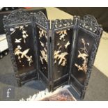 A late 19th Century Japanese shibyama ebonised three fold screen, applied with birds decorated on