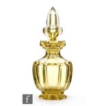 A late 19th Century Bohemian yellow glass cologne bottle of footed faceted form with flared