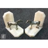 A pair of Art Deco white onyx bookends each mounted with a pewter horse, height 13.5cm. (2)