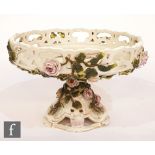 A late 19th Century Hutschenreuther tazza with a galleried bowl above a pierced splayed base