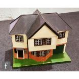 A large 1930s painted wooden dolls house with apex roofs and front opening section, width 76cm,