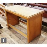 A 20th Century oak alter table, the moulded edge top on block legs united by rail stretchers inset