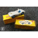 Two Dinky Toys diecast model cars, a #110 Aston Martin DB3 Sports in grey with blue interior,