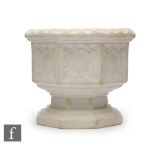 A 1920s Royal Worcester Parian travelling font, the octagonal body with Gothic panels, green printed