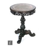 A 19th Century Anglo Indian carved hardwood circular tripod table with rouge marble inset top over a