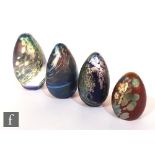 Four later 20th Century Okra glass paperweights of ovoid form, each decorated with iridescent