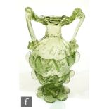 A 20th Century continental green glass winged vase in the 17th Century taste, of wrythen moulded