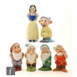 A Walt Disney part set of 1930s toothbrush holders in the form of Snow White together with five of