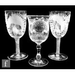 A near pair of early 20th Century goblets, the clear glass ovoid bowl engraved with ferns, above a