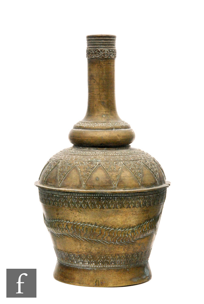 A Safavid style hammered brass vase, of bottle form, the shoulder decorated with a series of