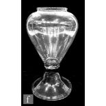 A large 18th Century leech jar, the clear glass of inverted baluster form with short collar neck and