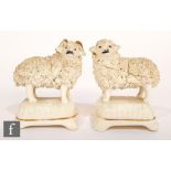 A pair of 19th Century Staffordshire figures of a ram and sheep mounted to cushion form bases. (2)