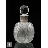 An early 20th Century clear crystal scent bottle of globular form with a pillar moulded body with