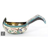 A Russian silver gilt and cloisonne enamelled miniature Kovsh decorated with multi-coloured