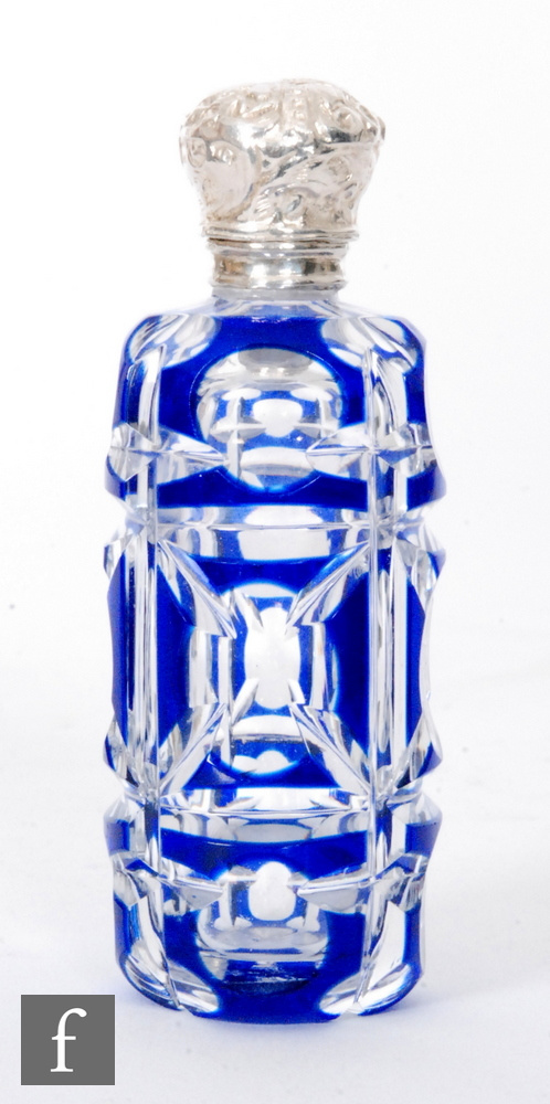 A late 19th Century silver and glass scent bottle, the blue flash cut cylindrical glass body below