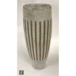 A later 20th Century studio pottery vase of sleeve form glazed in pale grey with horizontal bands in