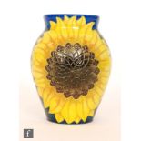 A Dennis China Works vase decorated to a design by Sally Tuffin with two sunflowers against a blue