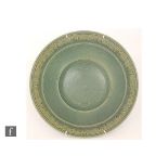 A large studio pottery bowl by Martin Homer, the whole glazed in green with a moulded border edge