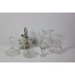 Cutglass: A large cutglass Water Ewer, cutglass Decanters, large vase, and other glass items.