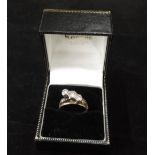 An Art Deco 18ct gold Ring, with three solitaire diamonds set high, flanked by two engraved bands,