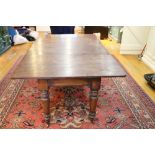 A 19th Century Irish mahogany extendable Dining Table, with four spare leaves, on turned legs,