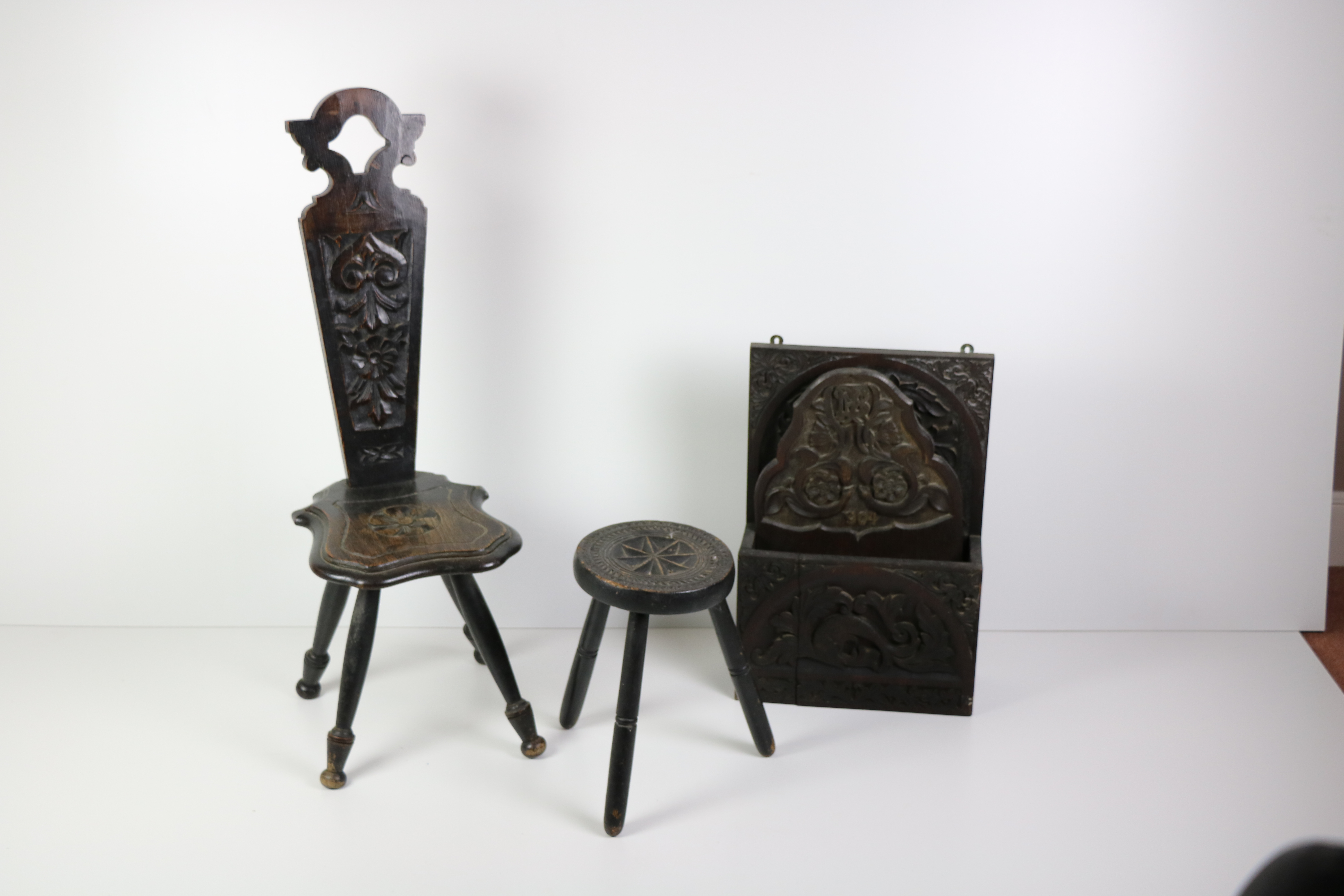 A heavy Arts & Crafts carved oak Hanging Magazine Rack, and a similar smaller ditto dated 1904,