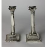 A pair of English silver Candlesticks, of Corinthian shape with stepped base, 24cms (7 1/2") high.