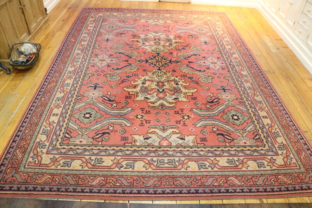 An attractive Turkish heavy woolen Carpet, with large pink ground central panel,