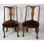 A pair of Edwardian walnut Dining Chairs, with upholstered seats on cabriole legs.