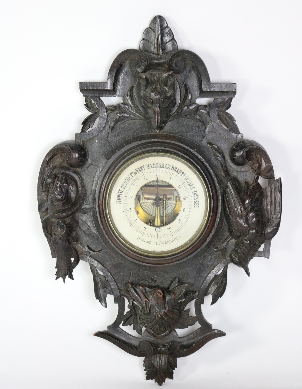 A carved and stained oak "Black Forest" type Aneroid Barometer, decorated with dog and wolf,