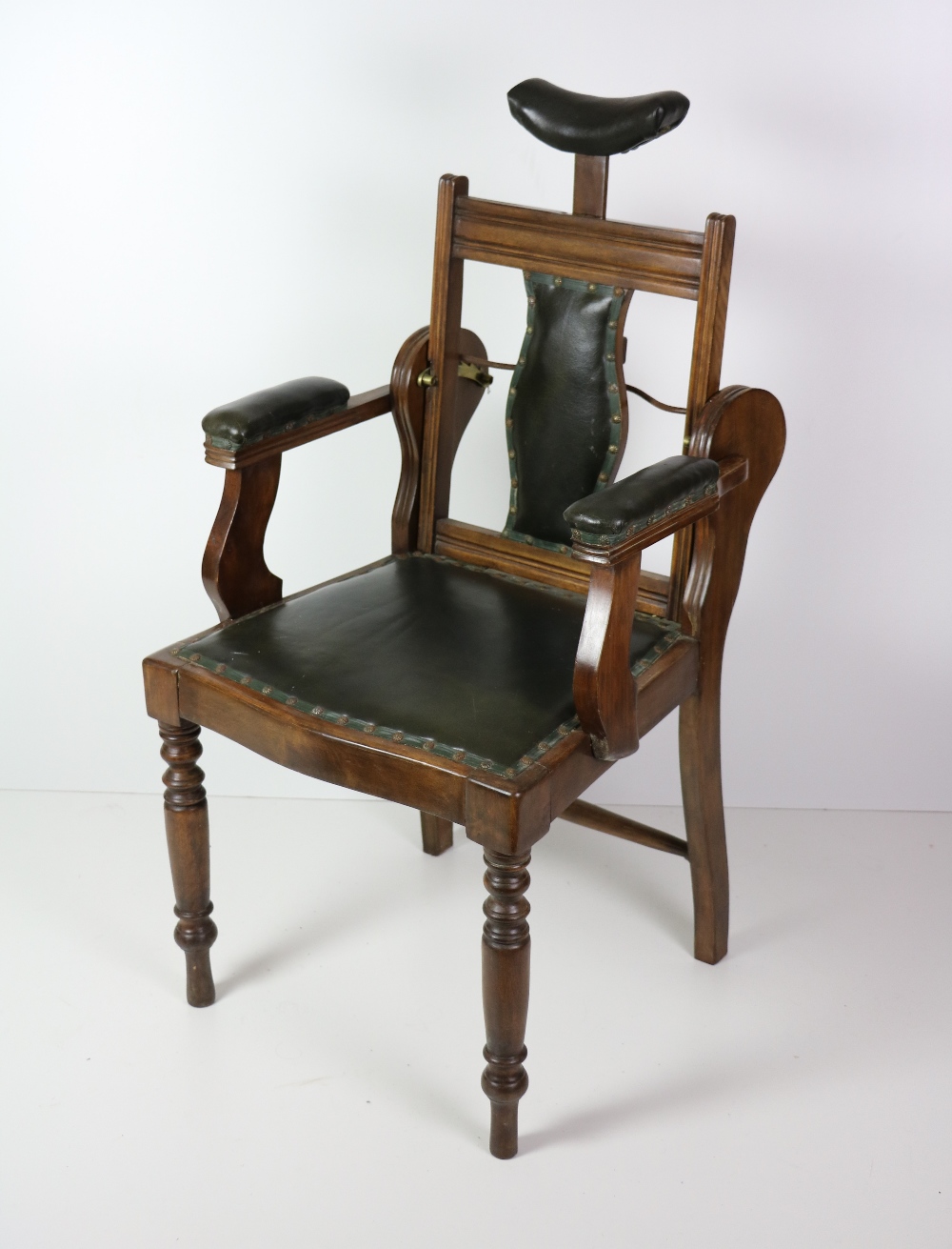 An Edwardian walnut Dentist's Chair, with leather back, seat and arms,