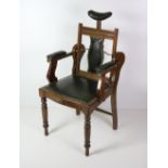 An Edwardian walnut Dentist's Chair, with leather back, seat and arms,