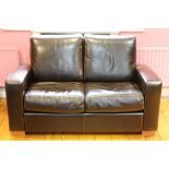 A modern two seater leather Couch.