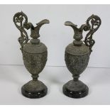 A pair of bronze Warwick type Vases, on circular marble bases with decorative design, each approx.