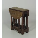 An unusual early 19th Century small oak gate-leg Table, with turned supports.