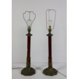 A pair of tole and ormolu mounted Table Lamps, raised on octagonal platform bases, now electrified,